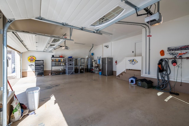 garage with a garage door opener and freestanding refrigerator