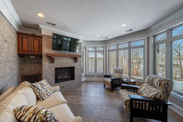 living room featuring a wealth of natural light, visible vents, and crown molding