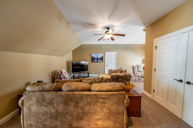 carpeted living area featuring vaulted ceiling, a ceiling fan, and baseboards