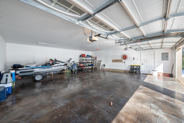 garage featuring electric panel and a garage door opener