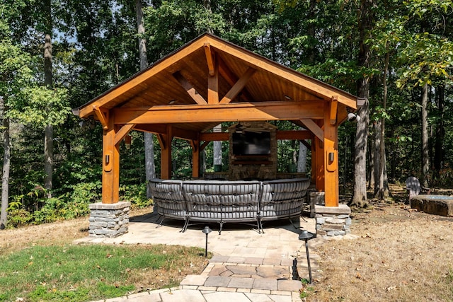 view of patio with a gazebo and a fireplace