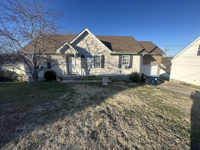 view of front of home with a front yard, a garage, and roof with shingles