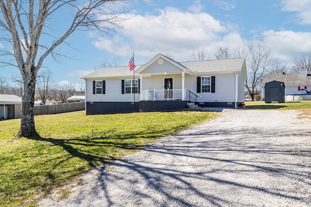 view of front facade with crawl space, covered porch, gravel driveway, and a front lawn