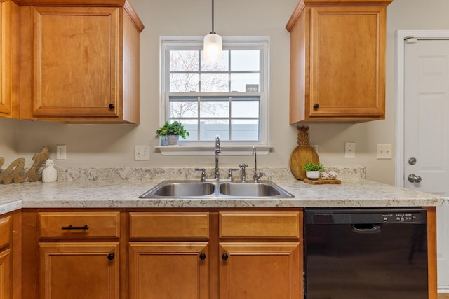 kitchen with dishwasher, light countertops, decorative light fixtures, and a sink