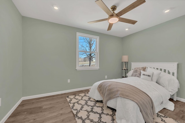 bedroom with a ceiling fan, recessed lighting, wood finished floors, and baseboards