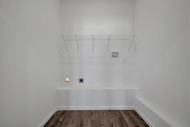 washroom featuring electric dryer hookup, dark wood-type flooring, washer hookup, baseboards, and laundry area