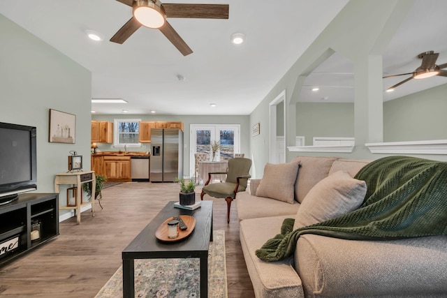 living room with recessed lighting, light wood-style floors, and ceiling fan