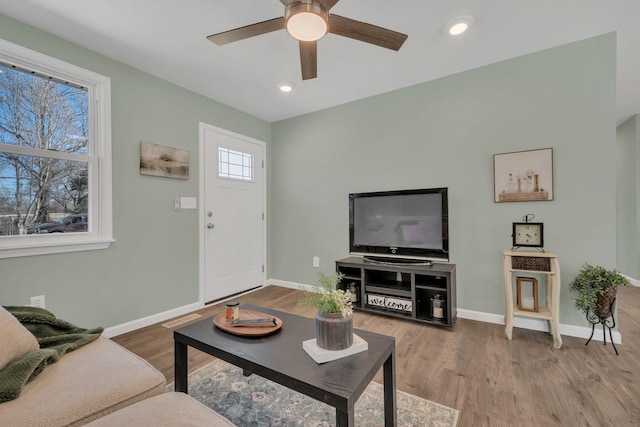 living room featuring visible vents, baseboards, recessed lighting, wood finished floors, and a ceiling fan