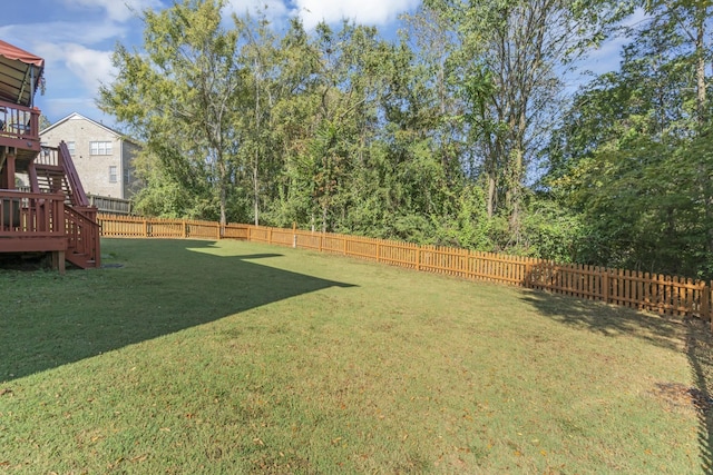 view of yard with stairs and a fenced backyard