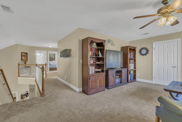 living room with carpet, visible vents, and baseboards