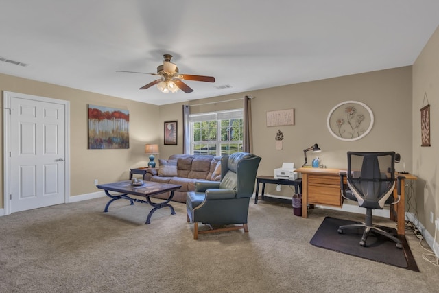 carpeted living area with visible vents, baseboards, and a ceiling fan