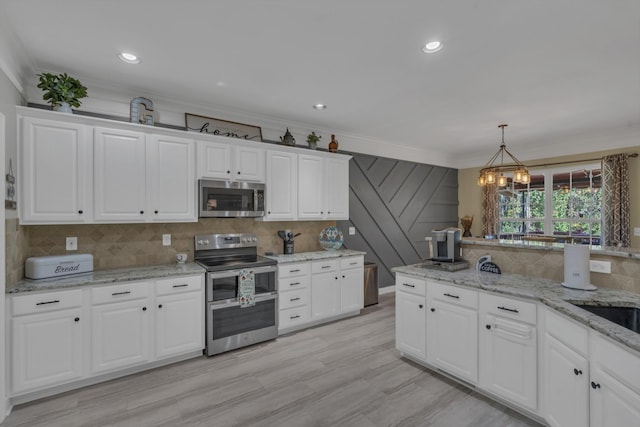 kitchen featuring ornamental molding, decorative backsplash, stainless steel appliances, white cabinets, and pendant lighting