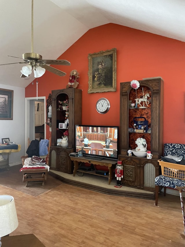 living room featuring ceiling fan, high vaulted ceiling, and wood finished floors