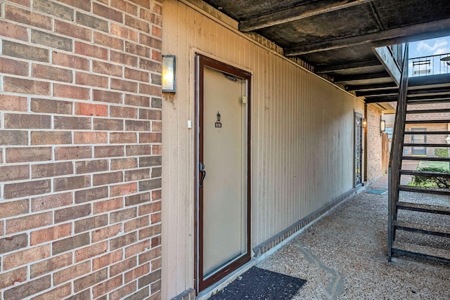 doorway to property featuring brick siding