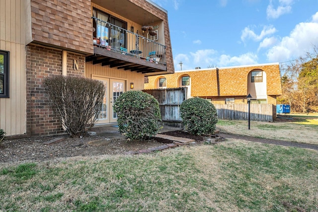 exterior space featuring a balcony and fence