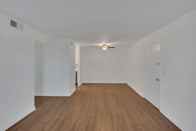 unfurnished room featuring visible vents, baseboards, wood finished floors, and a ceiling fan