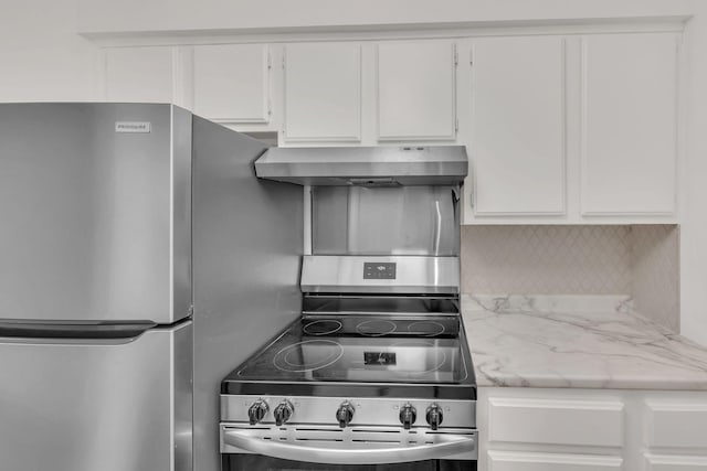 kitchen featuring white cabinets, appliances with stainless steel finishes, and wall chimney range hood