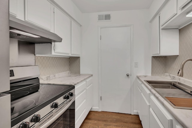 kitchen featuring white cabinetry, stainless steel range with electric stovetop, visible vents, and a sink