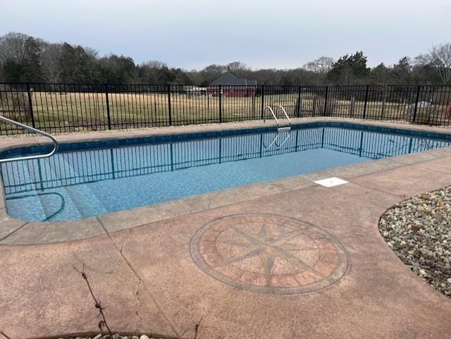 view of swimming pool featuring a fenced in pool and fence