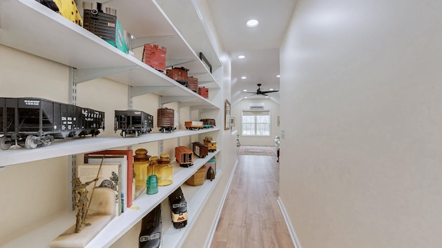 interior space featuring lofted ceiling, recessed lighting, wood finished floors, and baseboards