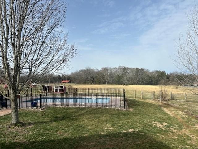 pool with a lawn and fence