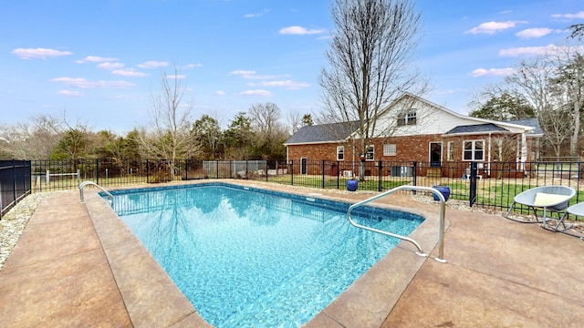 view of swimming pool with a patio, fence, and a fenced in pool