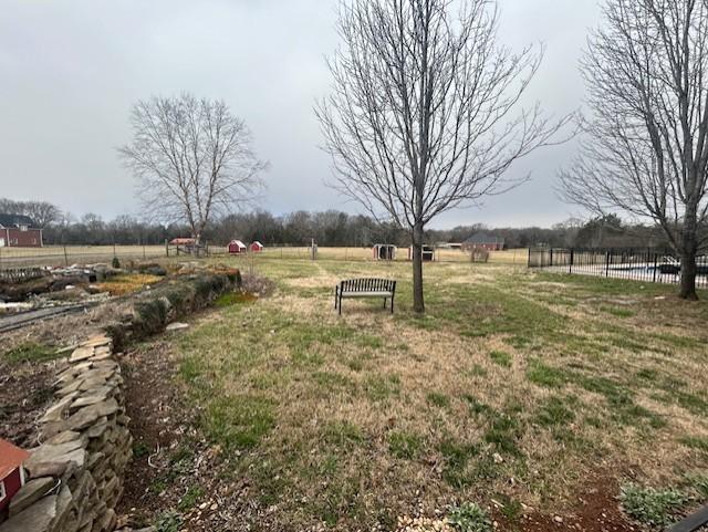 view of yard featuring a rural view and fence