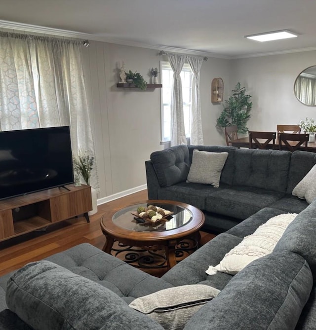 living area featuring crown molding and wood finished floors