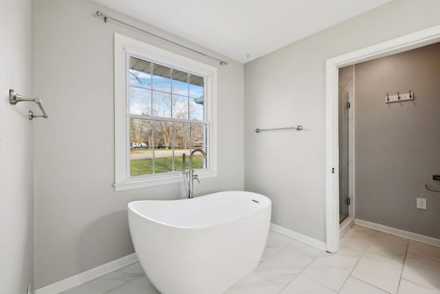 full bathroom with baseboards, marble finish floor, and a shower stall