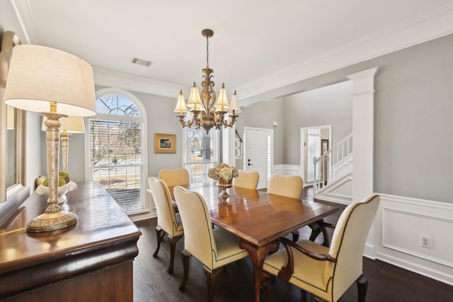 dining room with visible vents, stairway, wainscoting, crown molding, and dark wood-style flooring