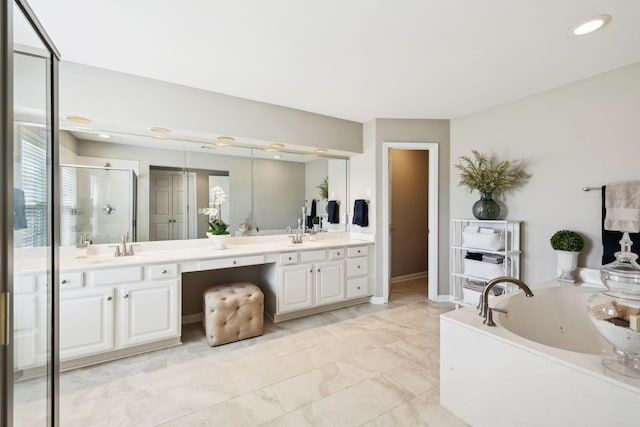 bathroom featuring a tub with jets, double vanity, recessed lighting, a stall shower, and a sink