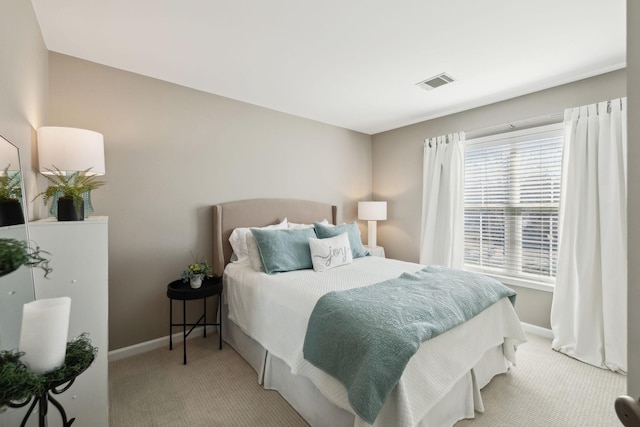 bedroom with visible vents, carpet flooring, and baseboards