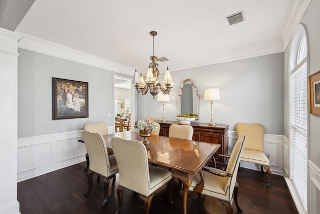 dining area featuring a wainscoted wall, dark wood-type flooring, and visible vents