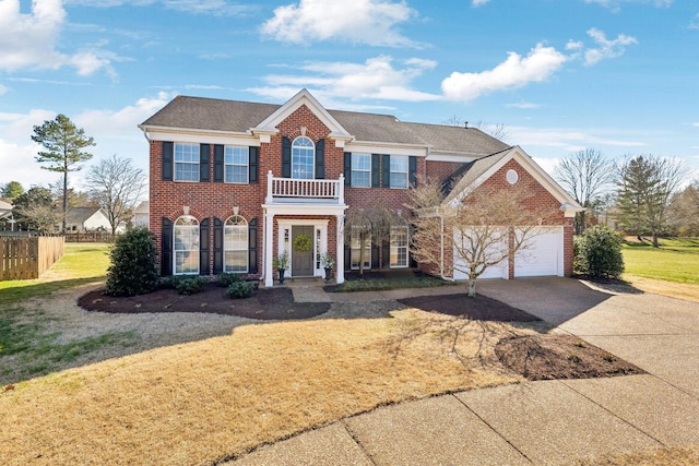 view of front of property featuring fence, driveway, an attached garage, a front lawn, and brick siding