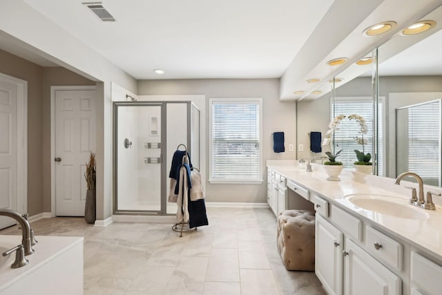 full bathroom featuring double vanity, visible vents, a shower stall, and a sink