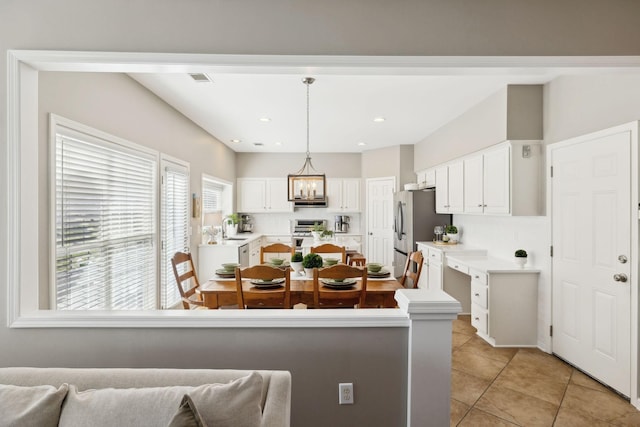 kitchen with white cabinetry, light countertops, a sink, and stainless steel appliances