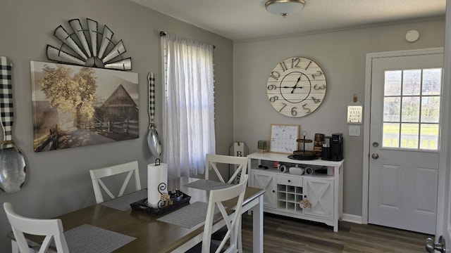 dining area with dark wood-style flooring