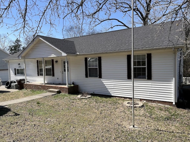 ranch-style home with a porch and a shingled roof