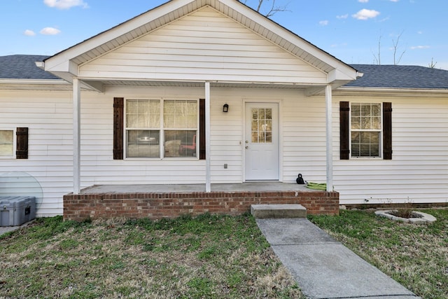 view of front facade featuring a porch and roof with shingles