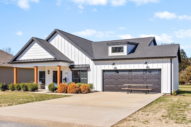 modern farmhouse style home featuring a standing seam roof, concrete driveway, a garage, board and batten siding, and metal roof