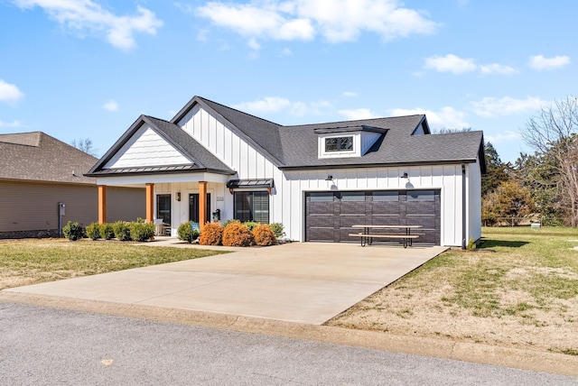 modern inspired farmhouse featuring board and batten siding, an attached garage, a front yard, and concrete driveway