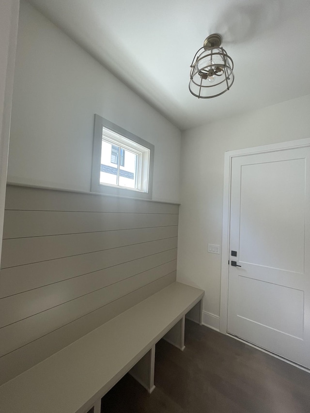 mudroom with dark wood finished floors