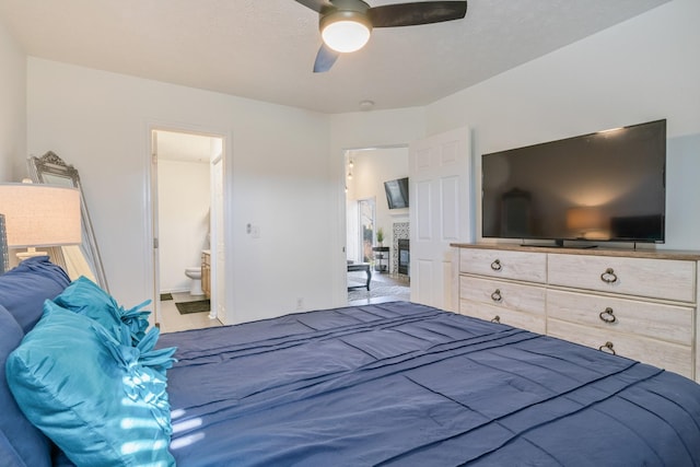 bedroom with ensuite bathroom and ceiling fan