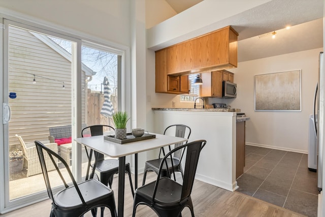 dining area featuring baseboards and dark wood-style floors