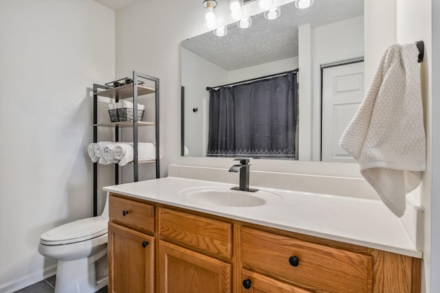 bathroom featuring curtained shower, a textured ceiling, toilet, and vanity