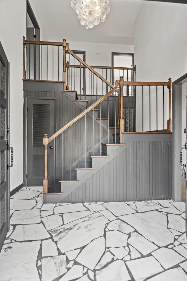 stairway featuring marble finish floor