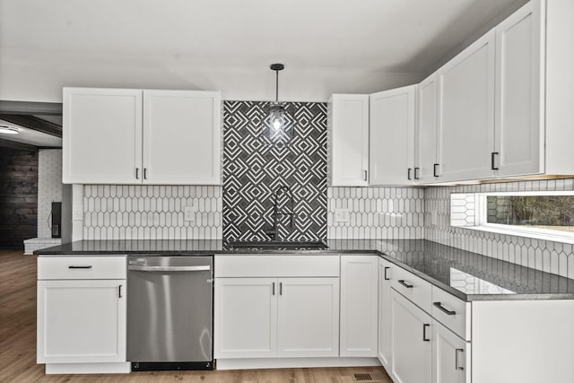 kitchen featuring light wood-type flooring, backsplash, pendant lighting, and white cabinets