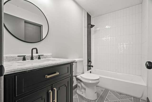 bathroom with tile patterned floors, toilet, vanity, and shower / tub combination