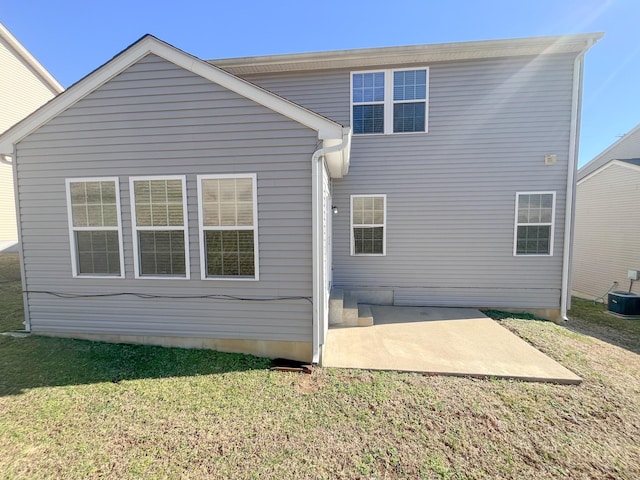 rear view of property with a patio, a lawn, and central AC unit