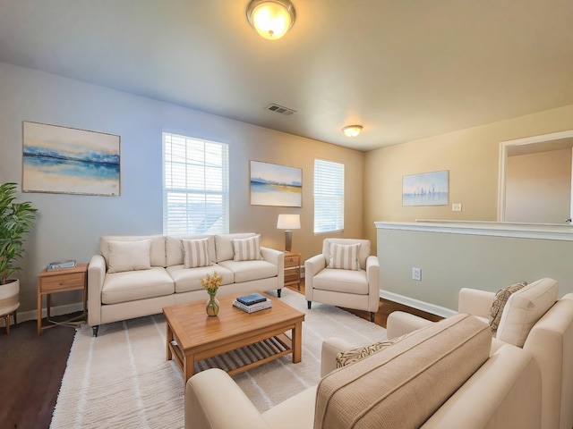 living room with baseboards and visible vents